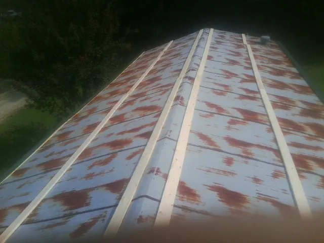 Rusted metal roof panels with new wood purlins before replacement — Storm Damage Roof Repair in Tatamy by Roofing Brothers